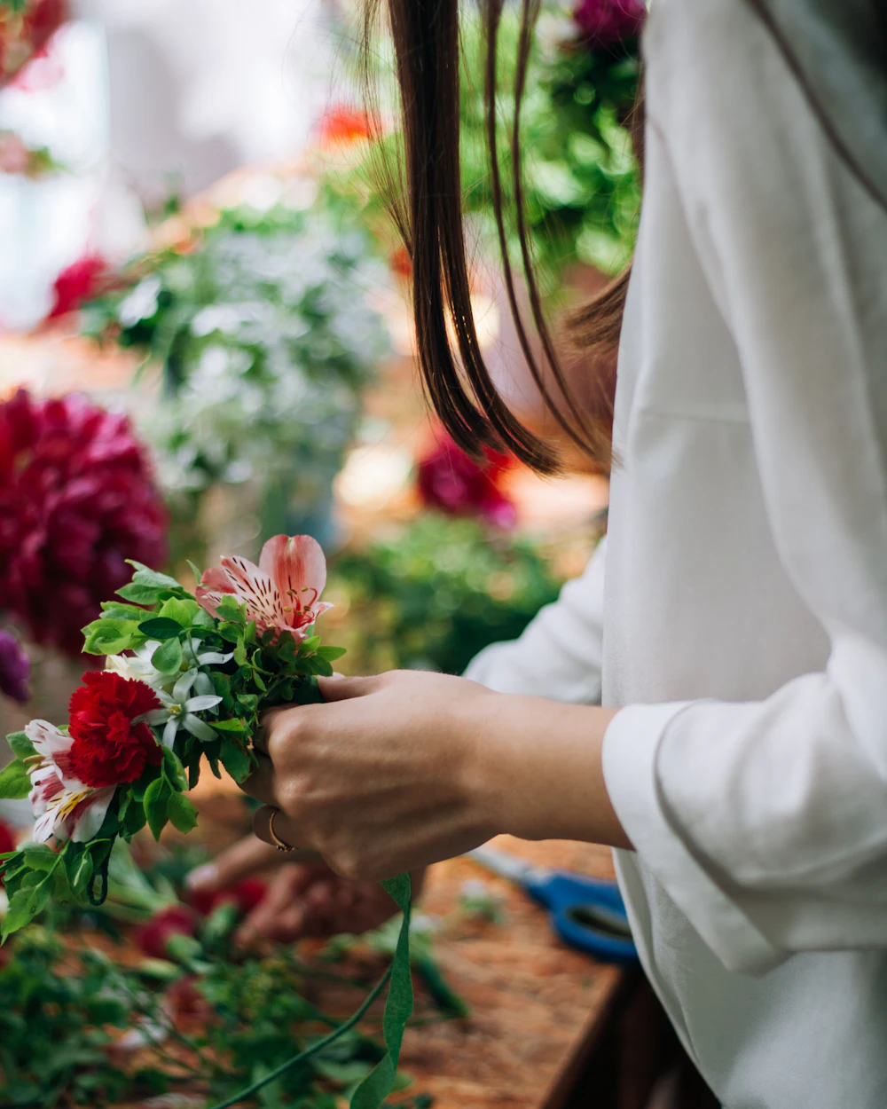 A florist arranging a bouquet in a flower shop